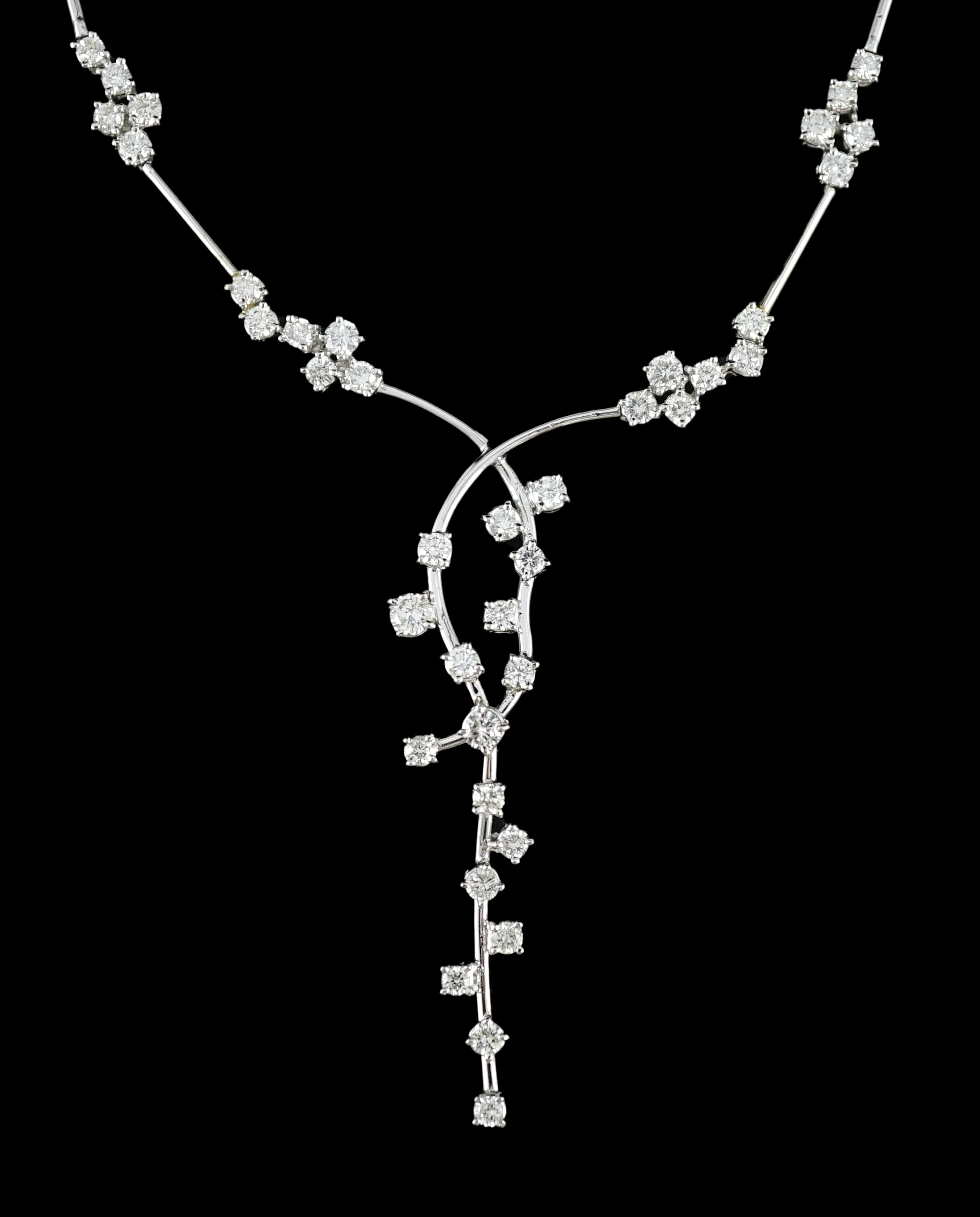 A modern 18k white gold and diamond cluster set necklace